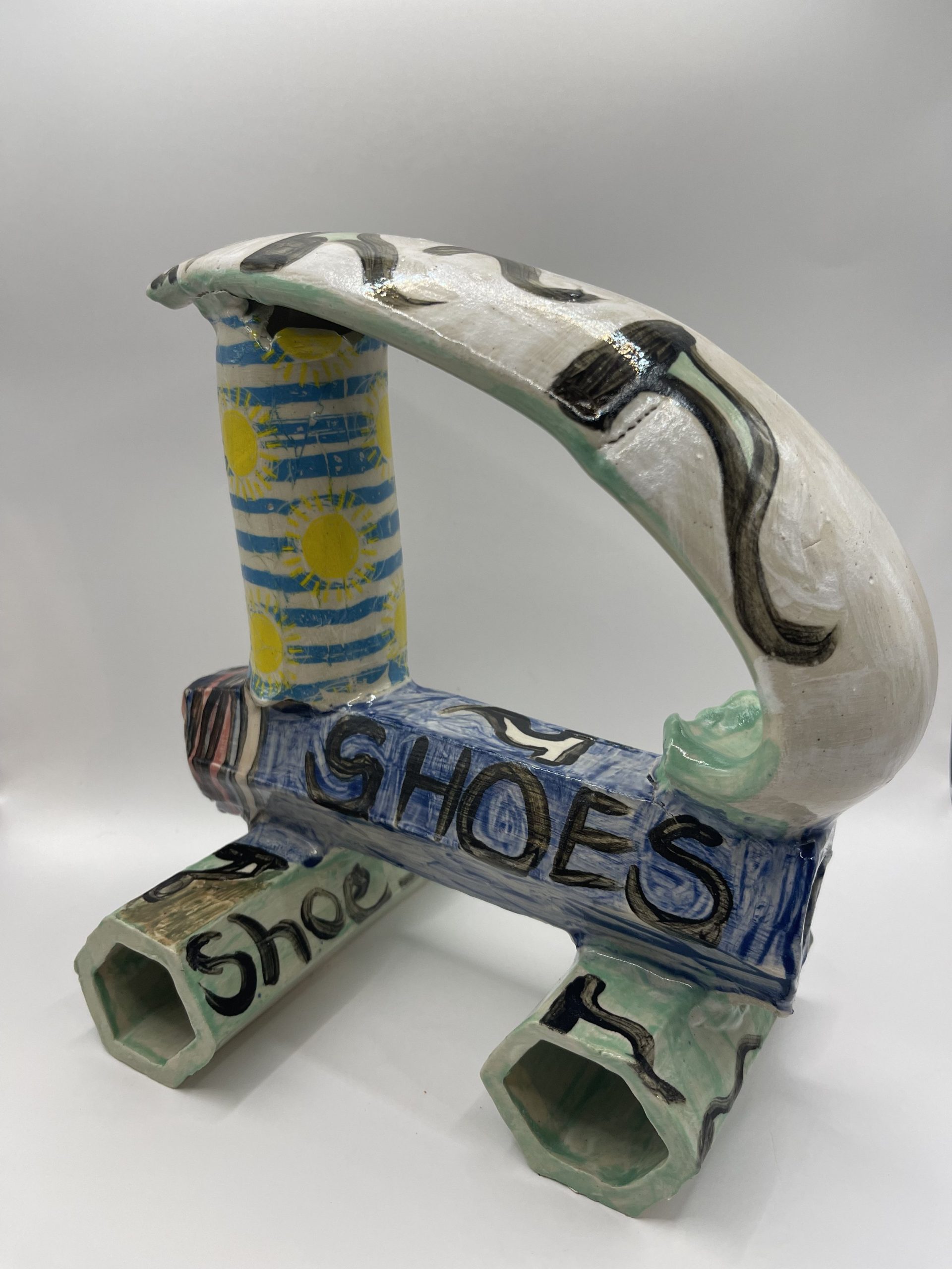  I extruded different shapes uses a white stoneware clay and experimented with underglaze decals , writing and different glazes. 