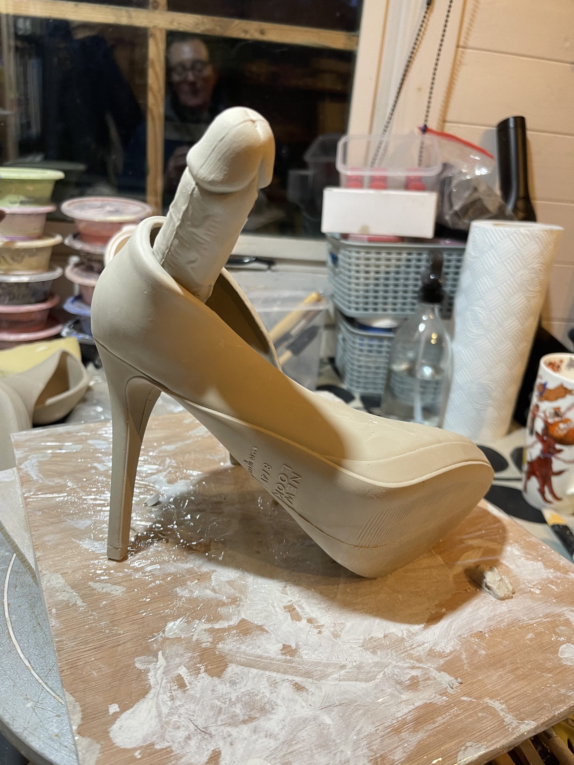  Trying to change the shape of the shoe form by manipulating the slip cast shoe. 