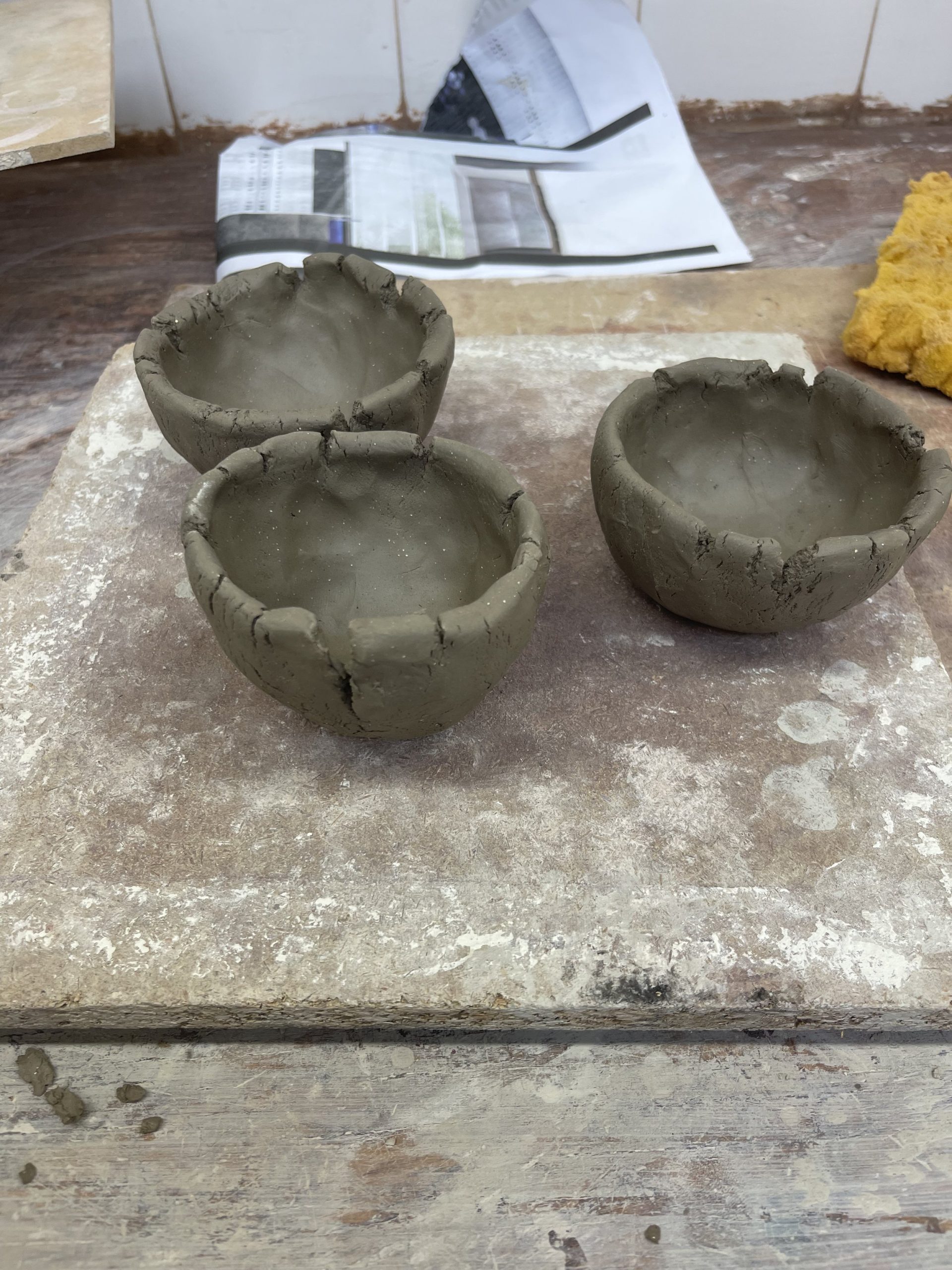  Hand building brief- using a pinching technique I created three vessel forms of a similar size and shape. It was quite challenging to ensure they were the same size! I left them to dry out as I quite liked the cracked effect. If I was going to use this technique I would spend more time making sure the sides were thiner . 