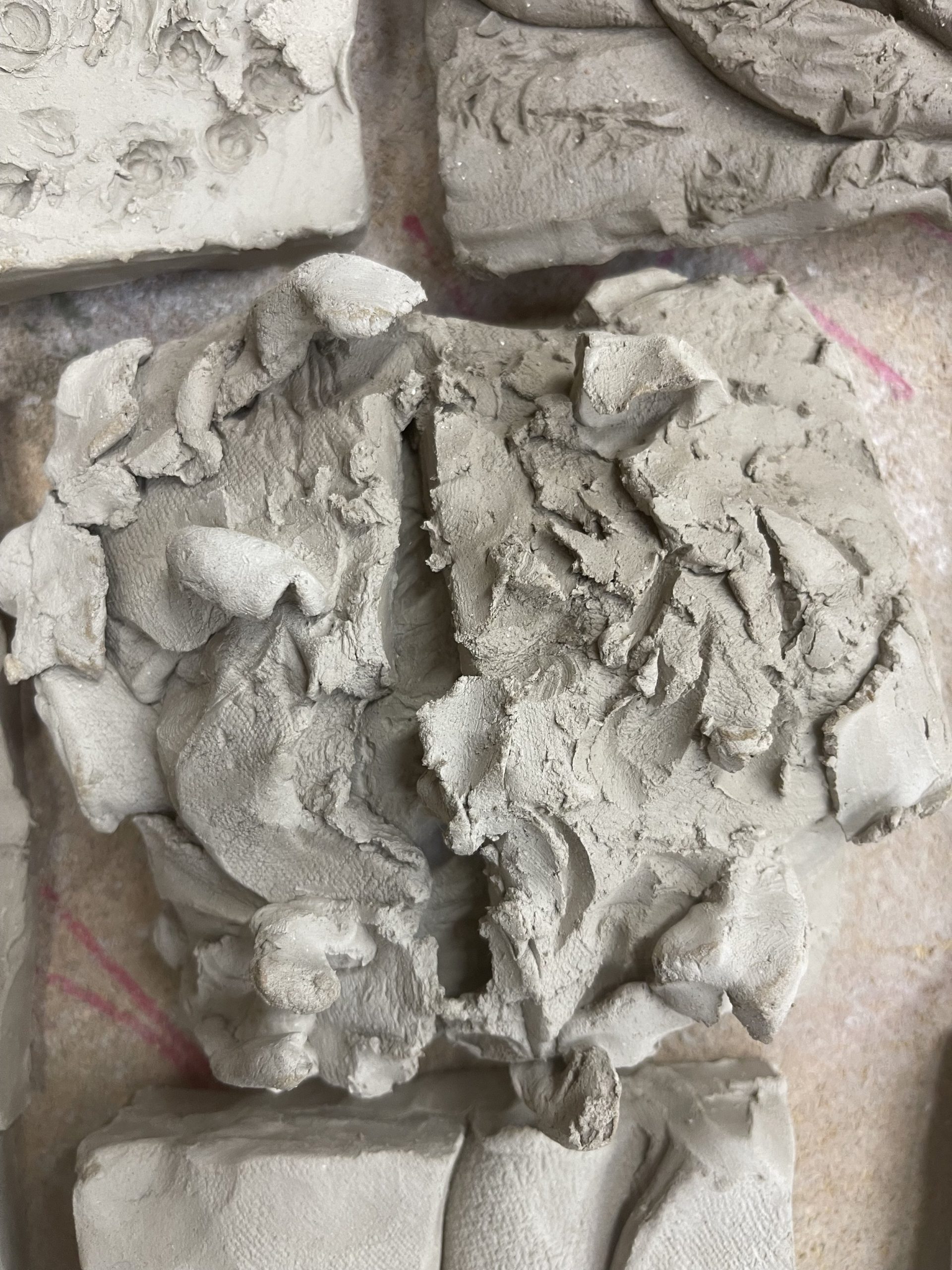 Smooth and flattened clay pressed together then dried with a blow torch created a ripped disengaged texture . 