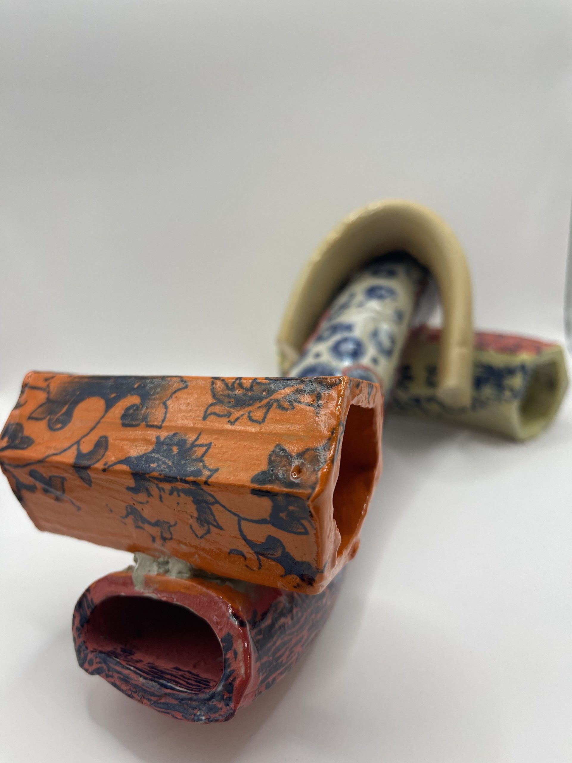  Buff clay extruded shapes manipulated and decorated with decals. 