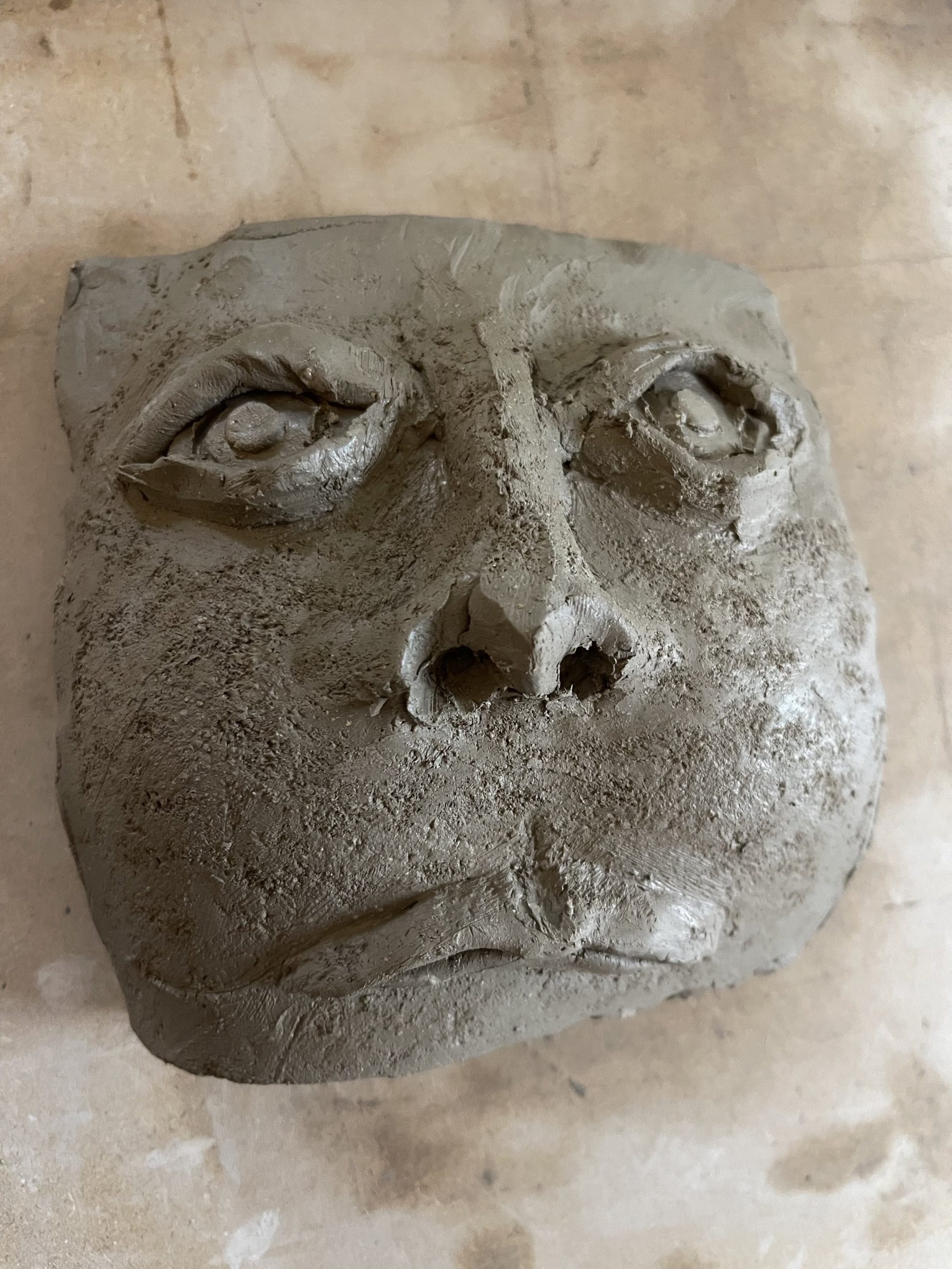  Soft clay tile pressed into by a nut then moulded from behind created expressions and a ruddy texture. Almost the need to display thoughts and feeling in a traditional format. 