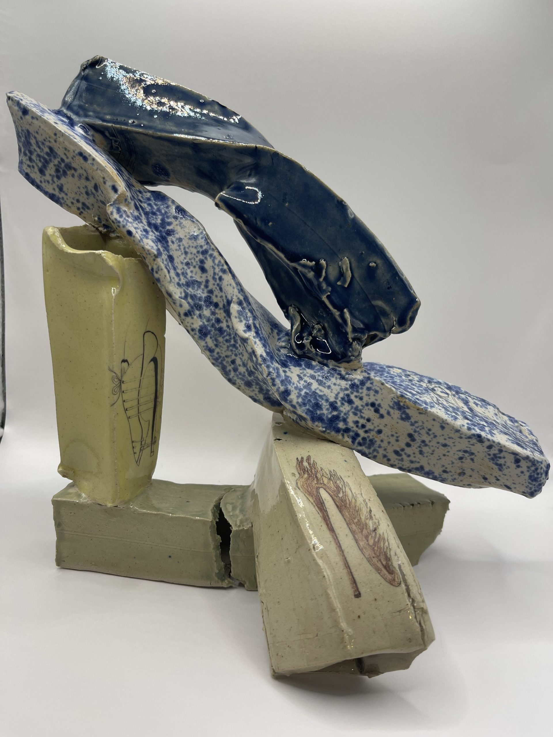  Whitestoneware clay extruded but manipulated and contorted to create different forms decorated with glaze and on glaze decals. This form is very busy perhaps reflecting a the busy independent women’s working day in shoes. 