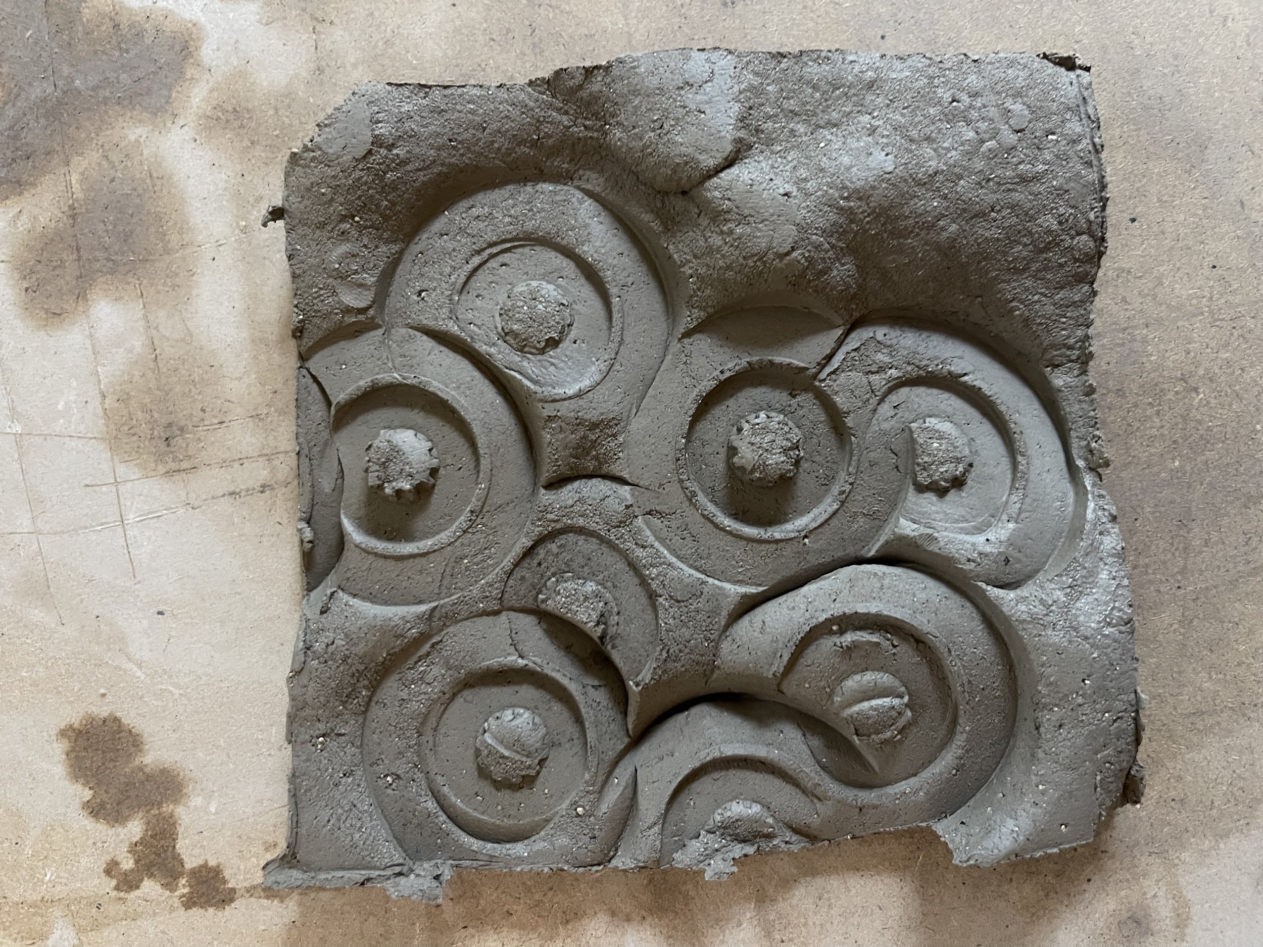  Using a metal bike tool the soft clay was stamped into then punched from behind leaving an undulating but formed texture. 