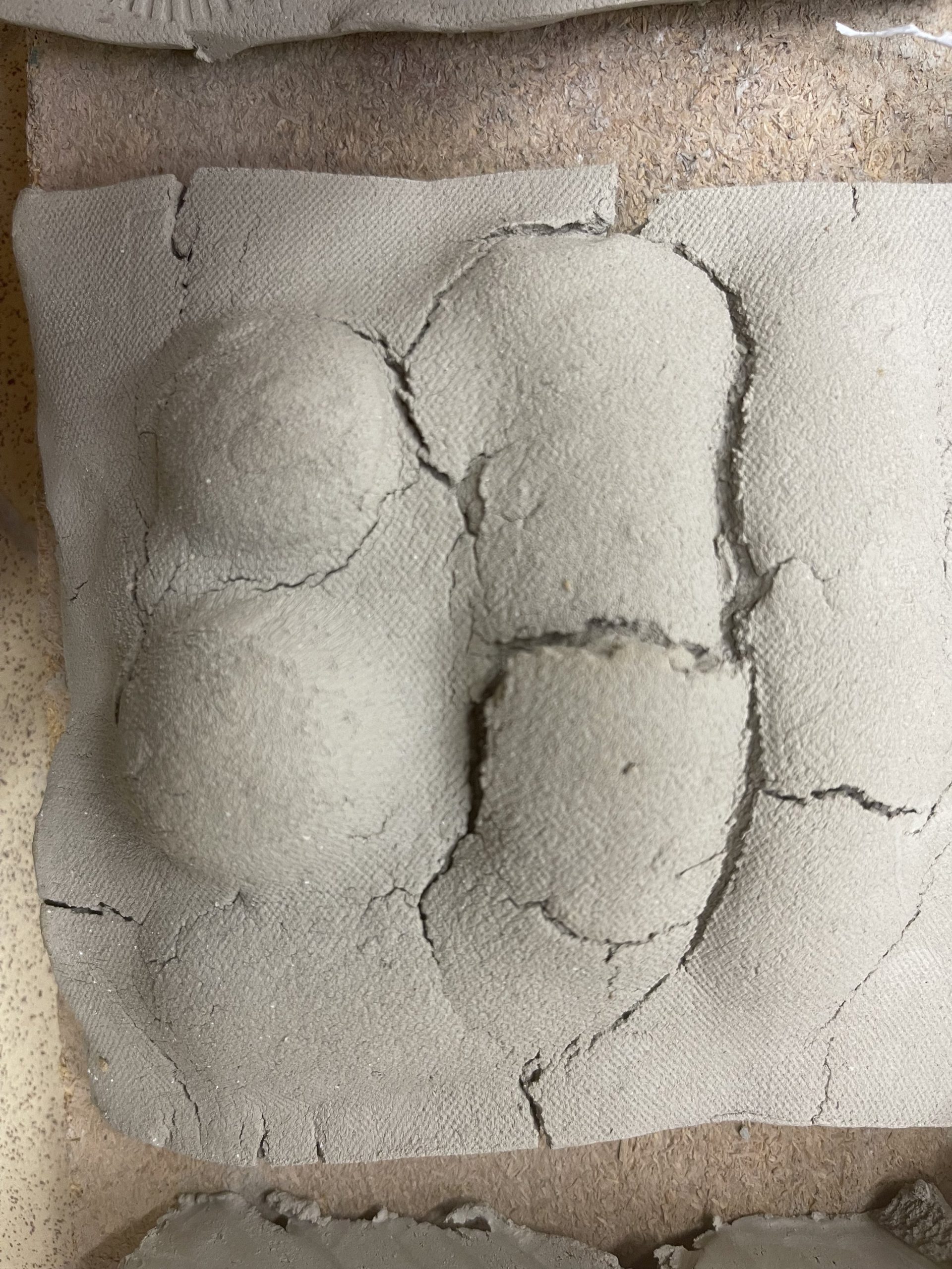  The clay tiles surface was dried using a blow torch and them pushed from behind using my fist .This created an undulating organic texture very similar to  ploughed fields left to dry in the sun. 